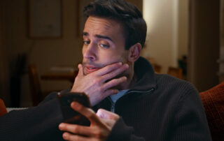 Man learning how to protect himself from phishing and smishing scams.